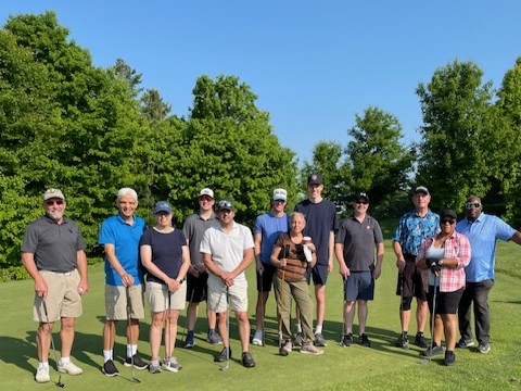 A dozen church members on a golfing green