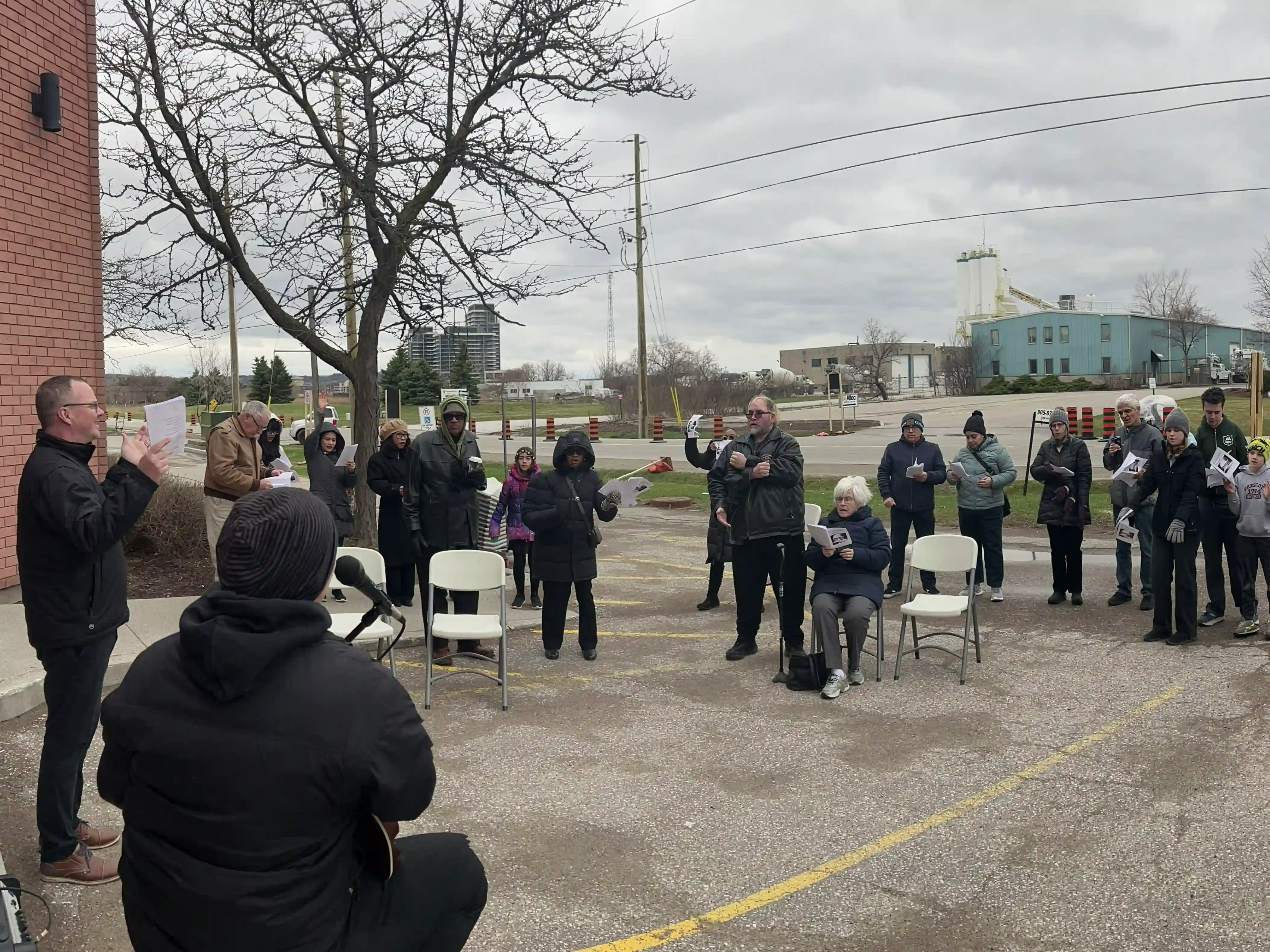 The Khi church gathers outside to worship in a circle together