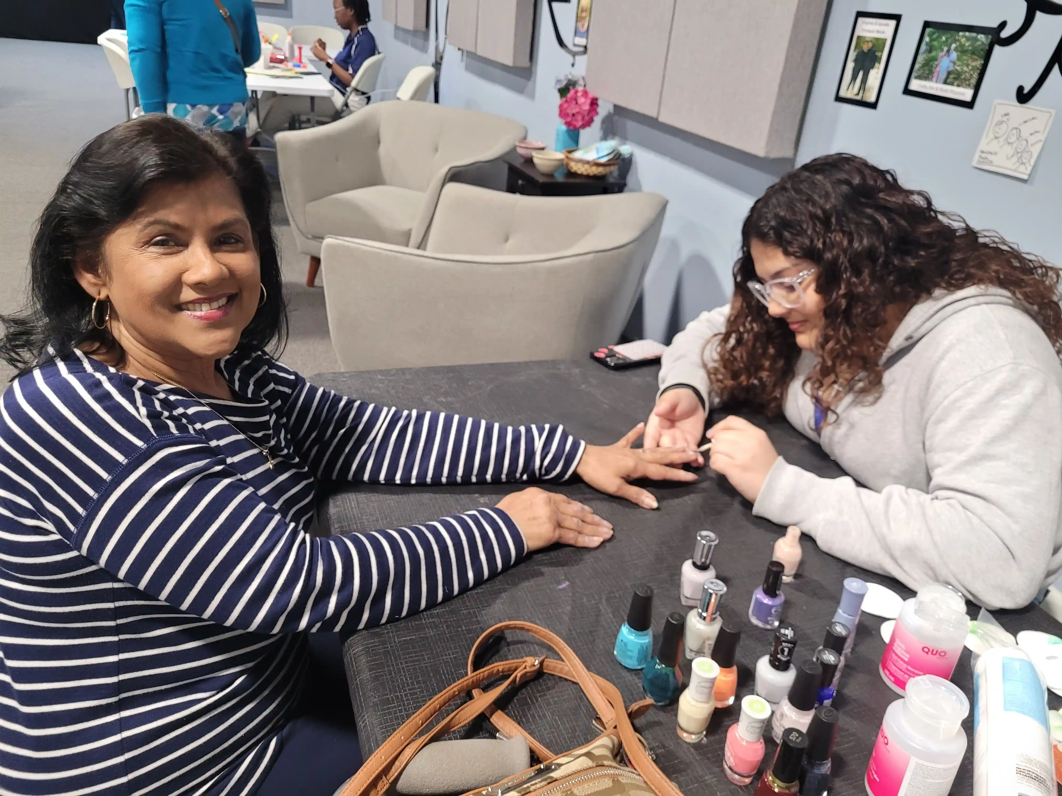 A woman paints another woman