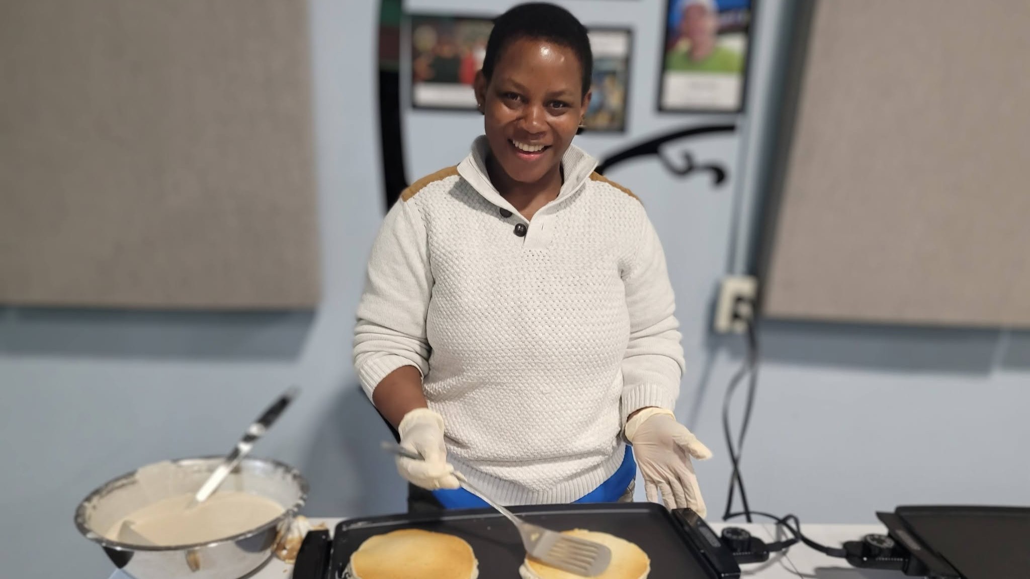 A woman serves pancakes on shrove Tuesday