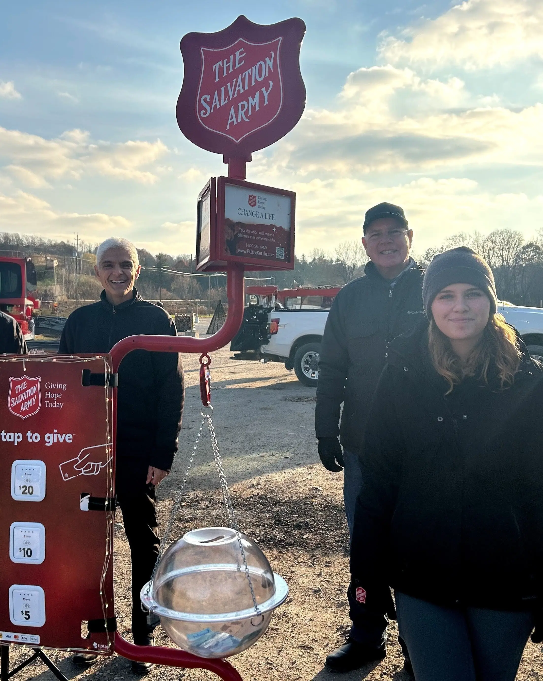 Milton volunteers outdoors with a Salvation Army kettle 